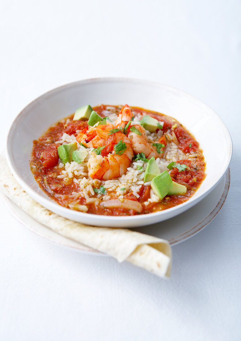 Rice in spicy tomato sauce,avocado and shrimps