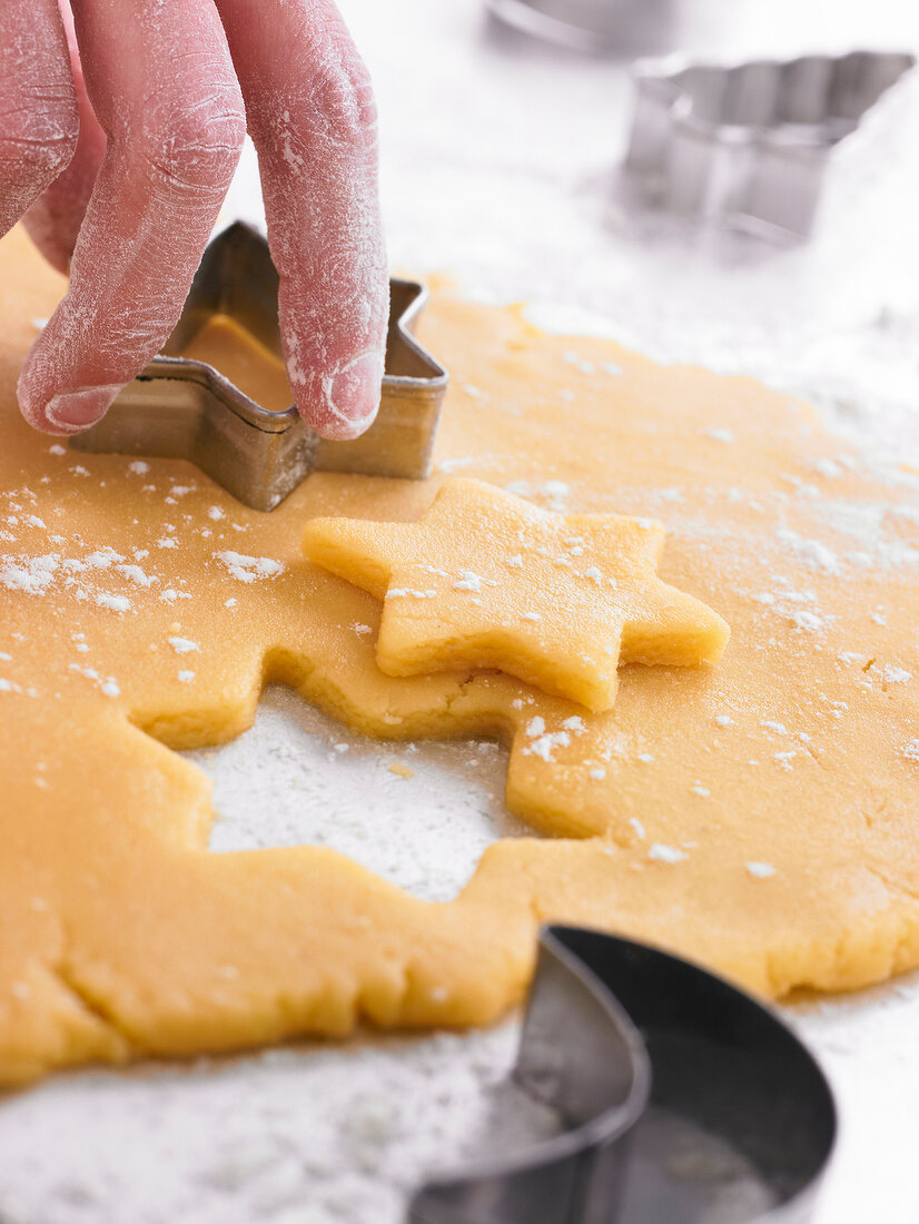 Cutting out stars in the cookie dough with a biscuit cutter