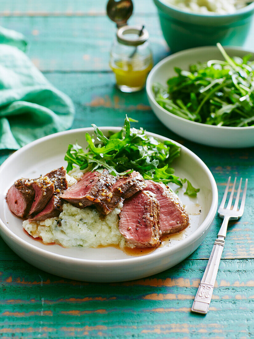 Roast beef with homemade herb mashed potatoes,rocket lettuce salad