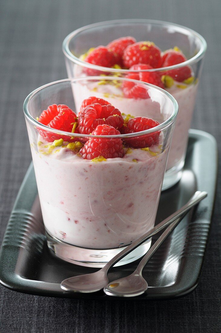 Raspberry mousse topped with crushed pistachios and raspberries
