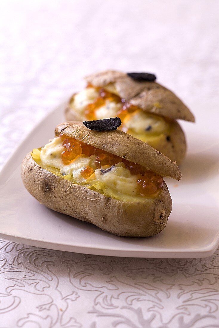 Baked potatoes garnished with truffled mascarpone and salmon roe