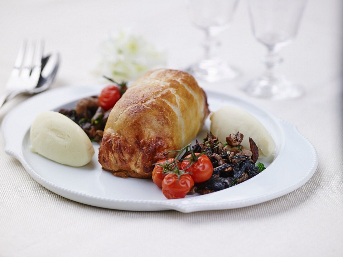 duckling in flaky pastry crust ,potato and celeriac mash,mushroom fricassée and roasted tomatoes