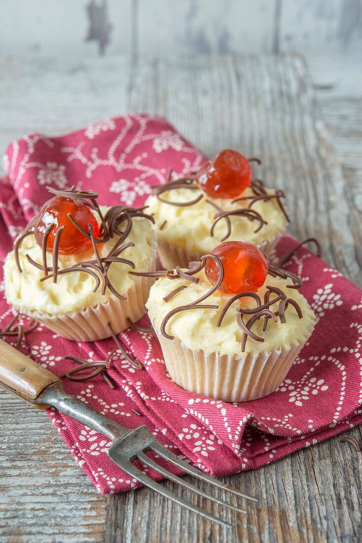 Cupcakes topped with a candied cherry