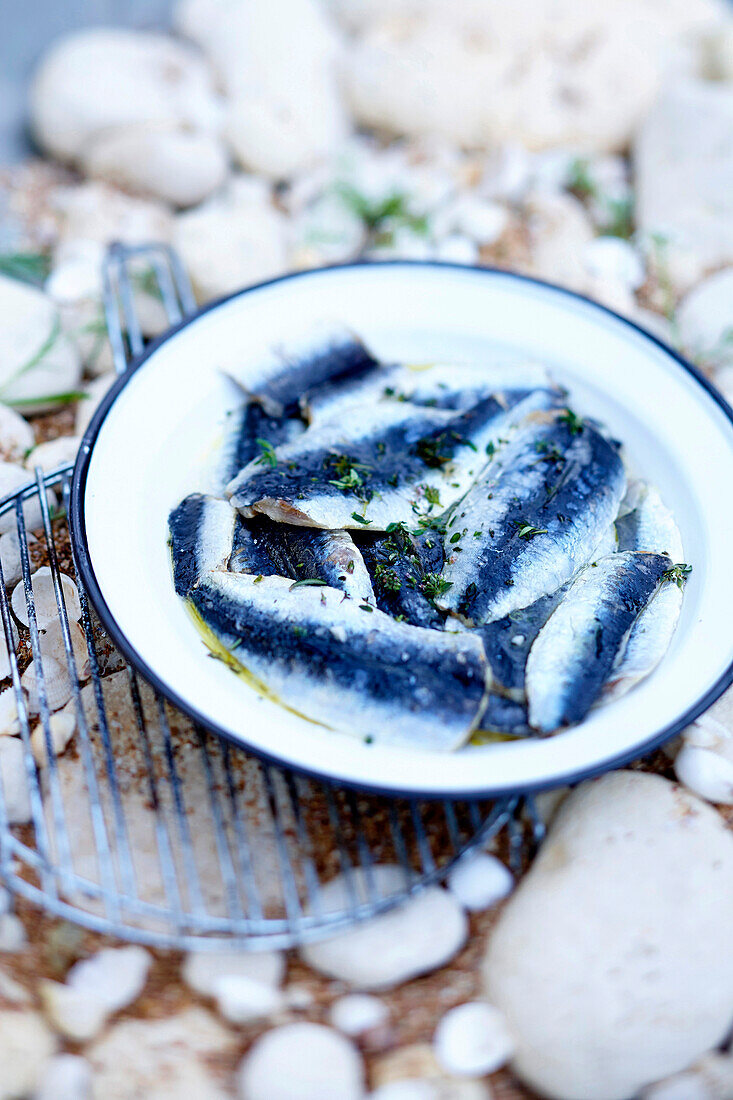 Anchovies marinated in oil and herbs