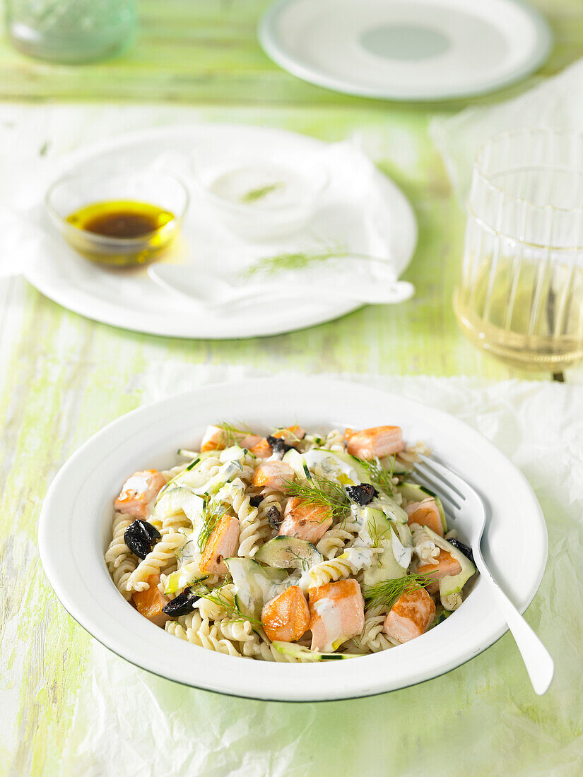 Pasta salad with salmon, cucumber, olives and dill