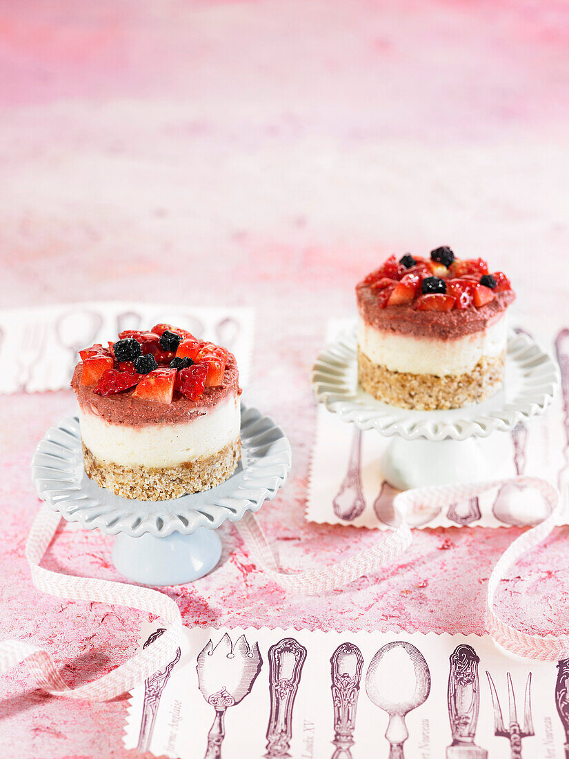 Small cheesecakes with cashew crust, lemon and wild berries