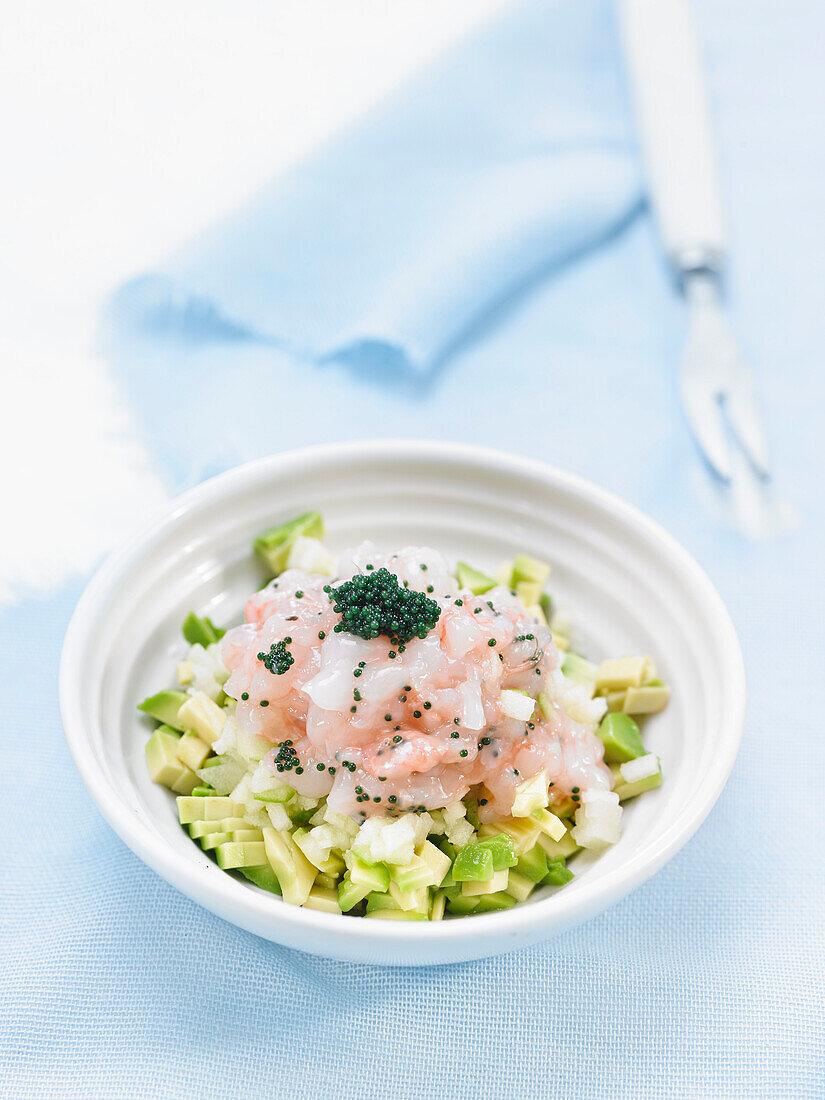Tartar of scampi and avocado with colored fish eggs
