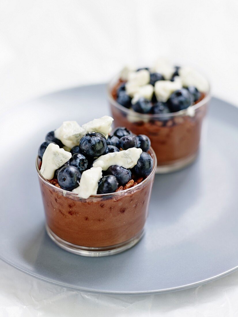 Chocolate mousse with puffed rice, blueberries and gorgonzola in glasses