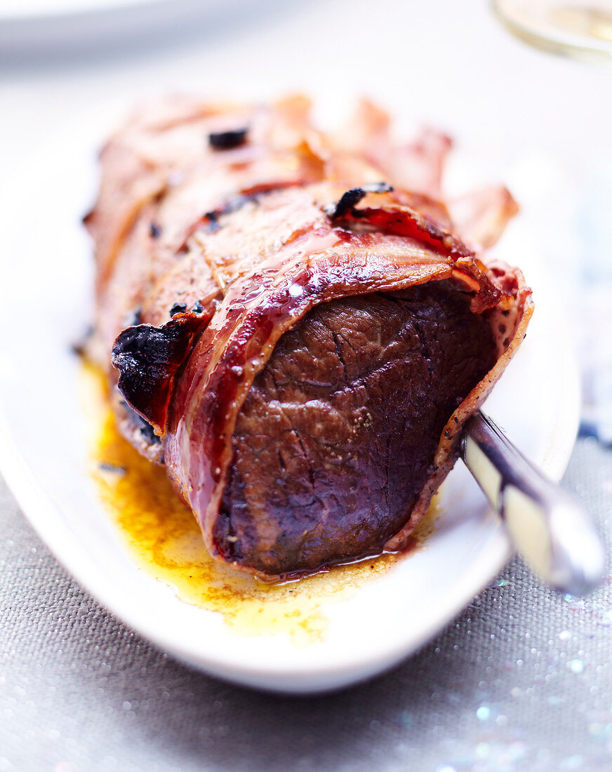 Roast beef wrapped in bacon with truffles