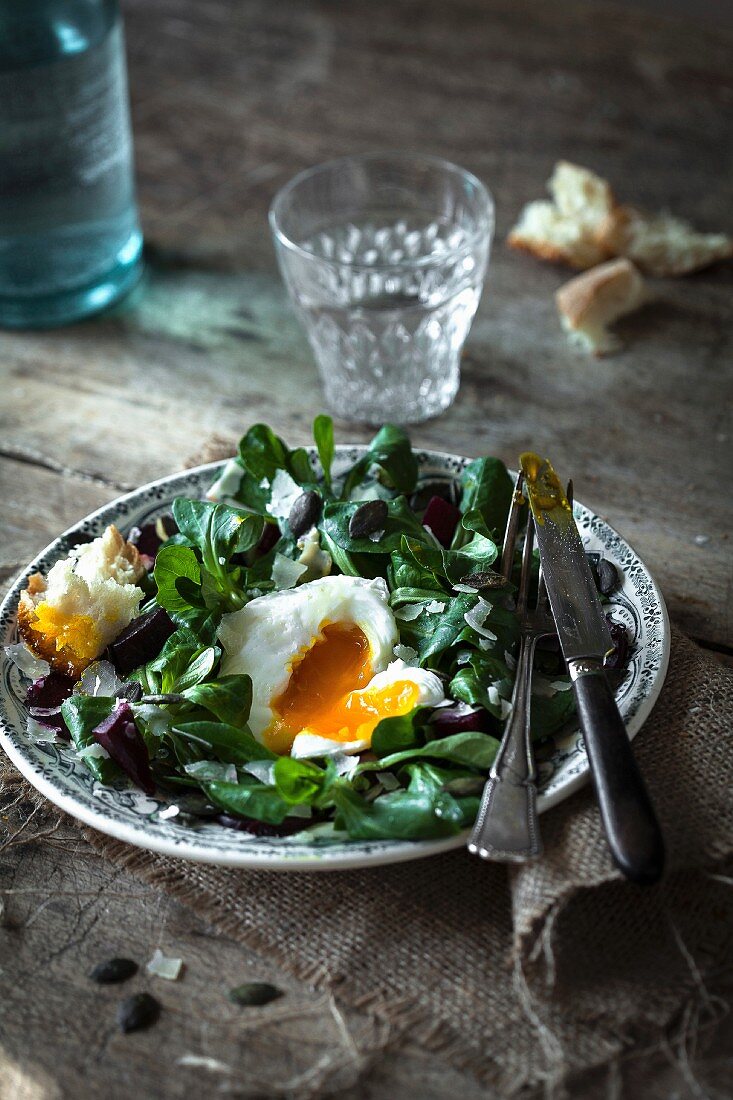 Corn lettuce,beetroot and squash seed salad with a poached egg