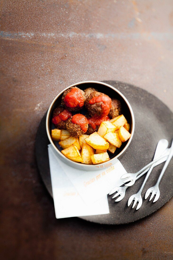 Meatball in tomato sauce with sauteed potatoes