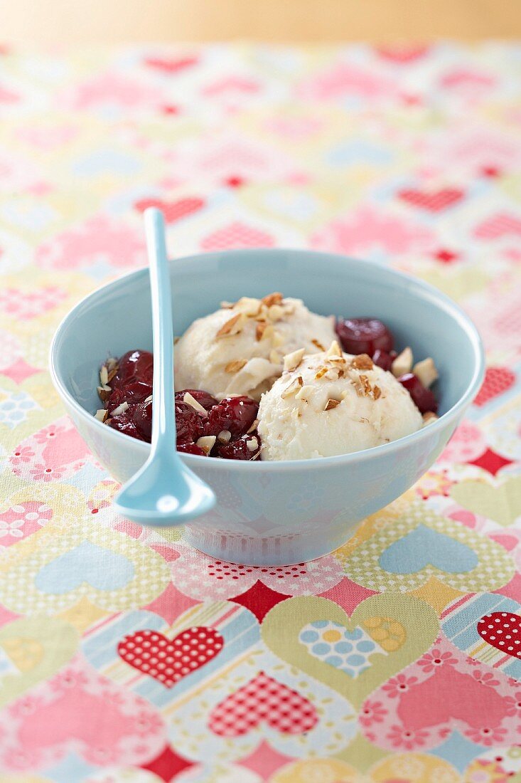 Almond milk ice cream with crushed almonds and preserved cherries