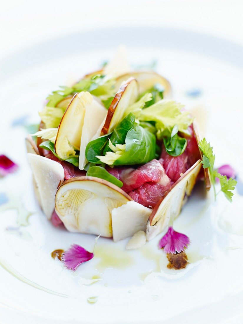 Red tuna tartare surrounded with thinly sliced mushrooms,lettuce and parmesan