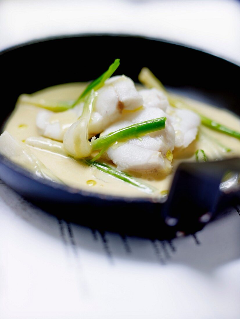 Bourride-style poached monkfish with spring onions and leeks