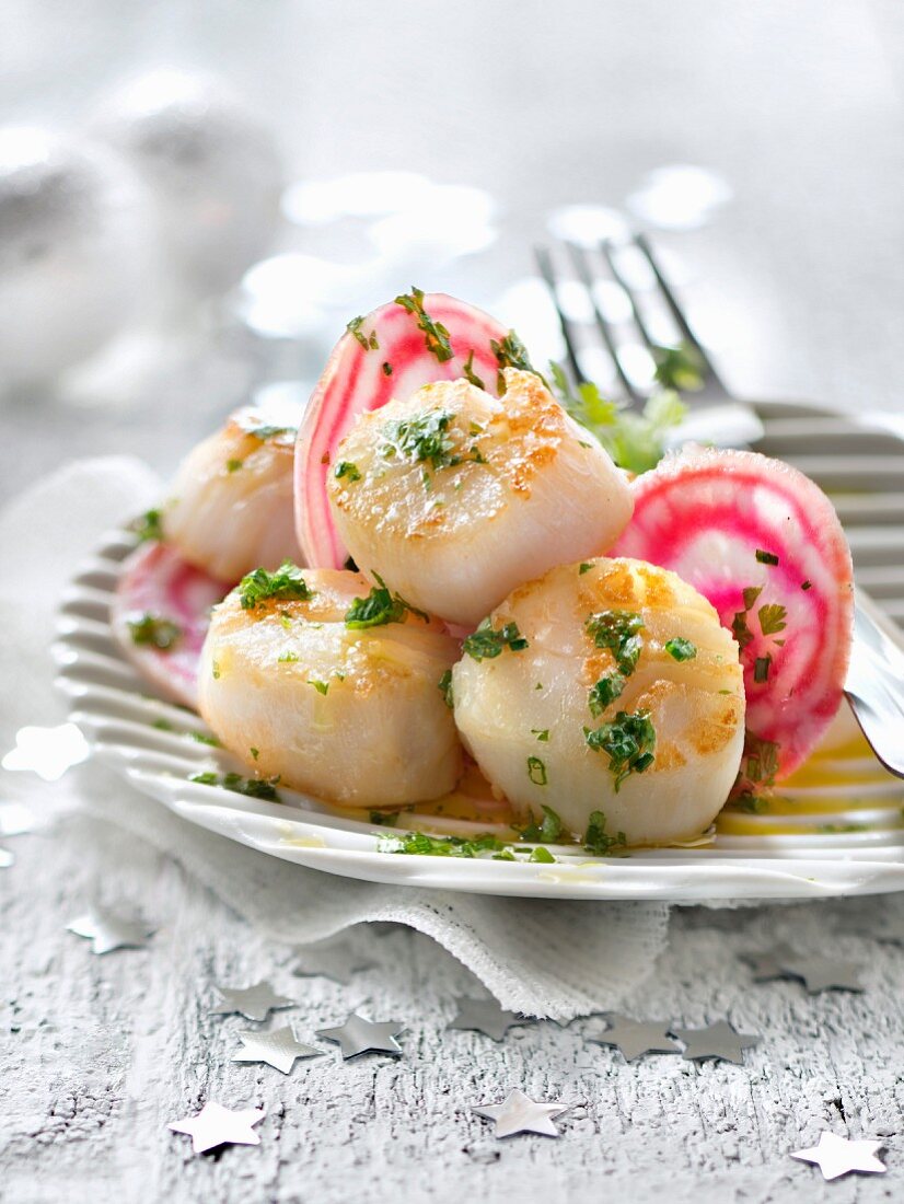 Scallops sauteed in salted butter and raw beetroot in herby vinaigrette