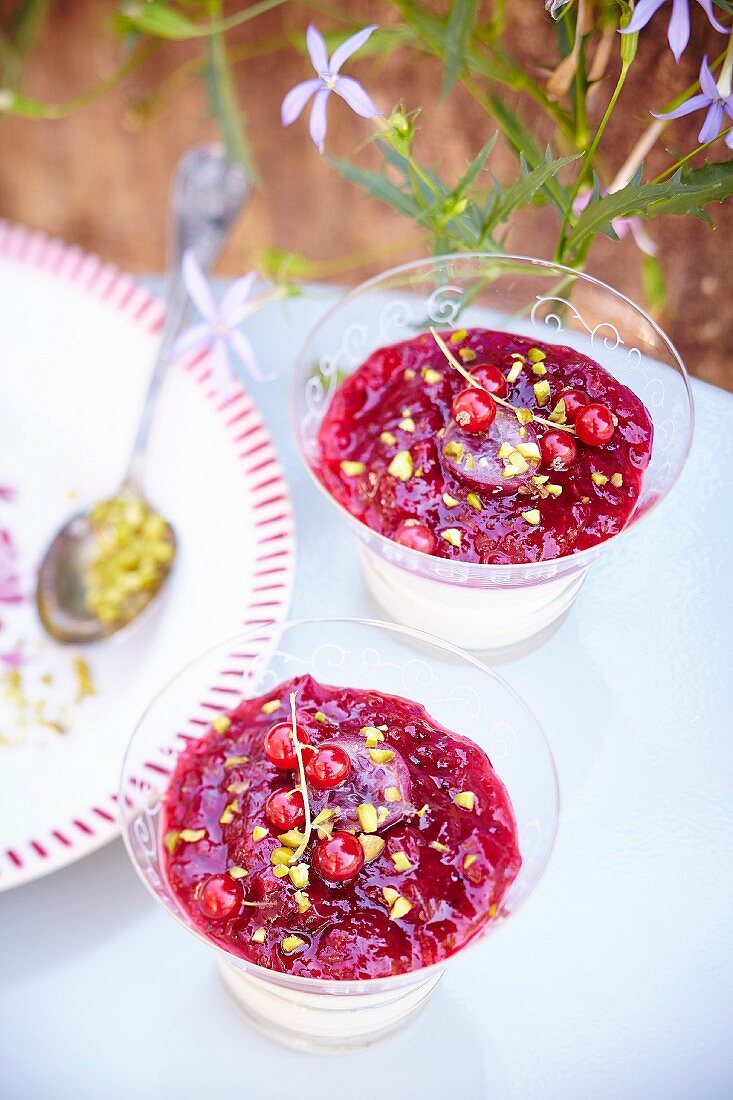 Fromage blanc with redcurrant coulis and pistachios served in glasses