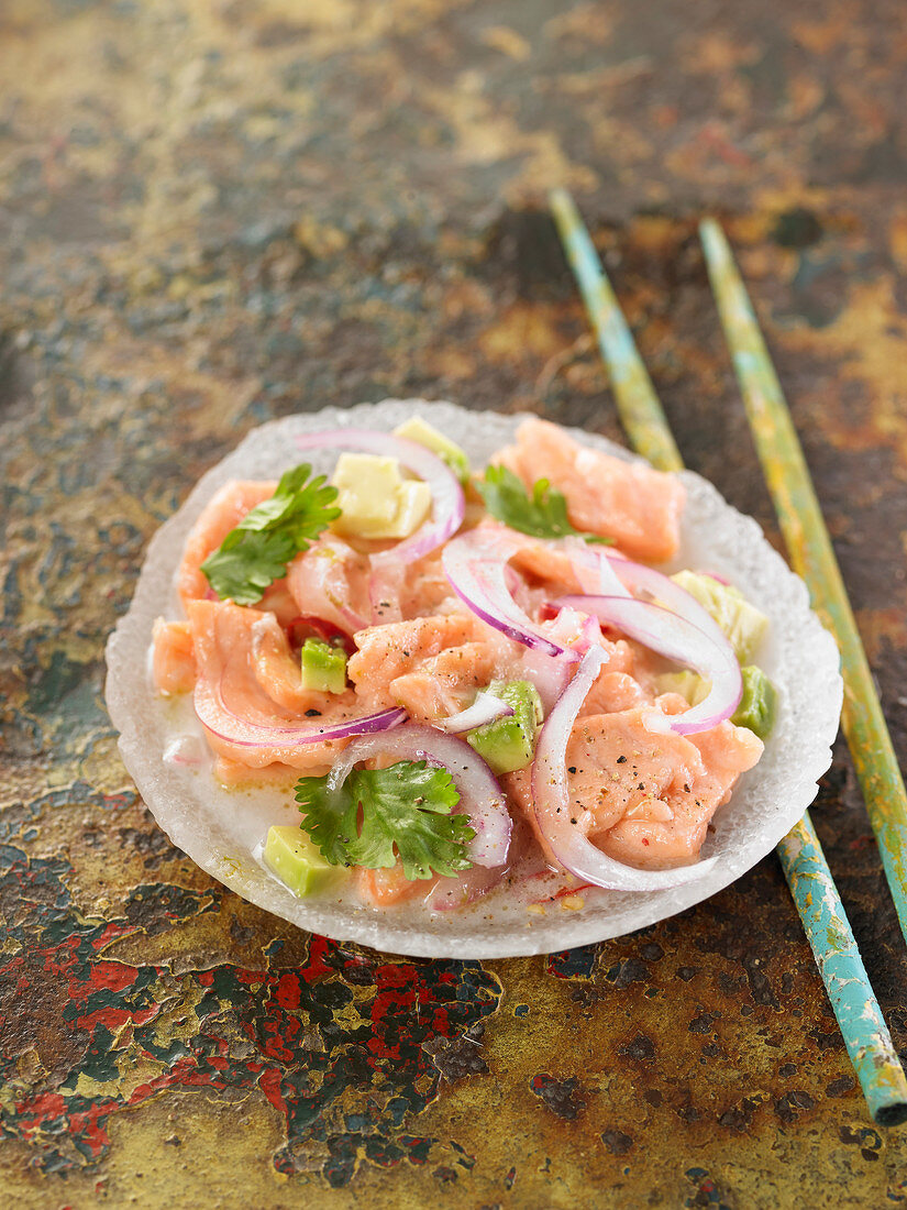 Salmon ceviche with red onions, coconut milk and lemon juice