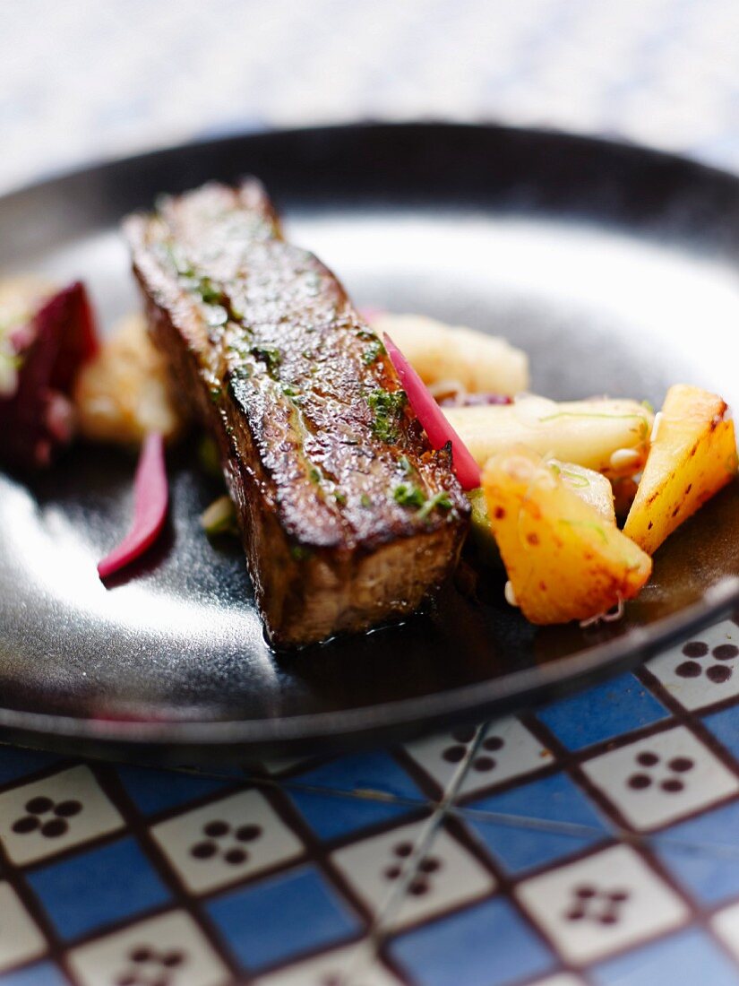 Pork breast with parsley butter,pineapple,salsifies and crisp radishes