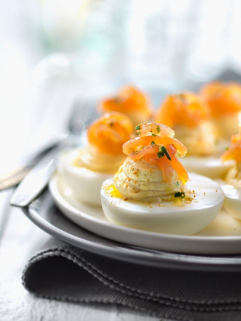 Hard-boiled eggs with creamy curry stuffing and topped with smoked trout