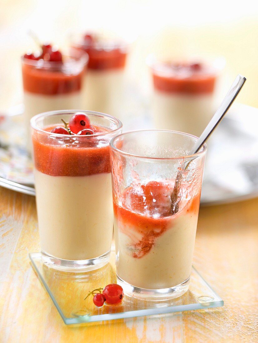 Vanilla cream dessert with redcurrants and raspberry coulis