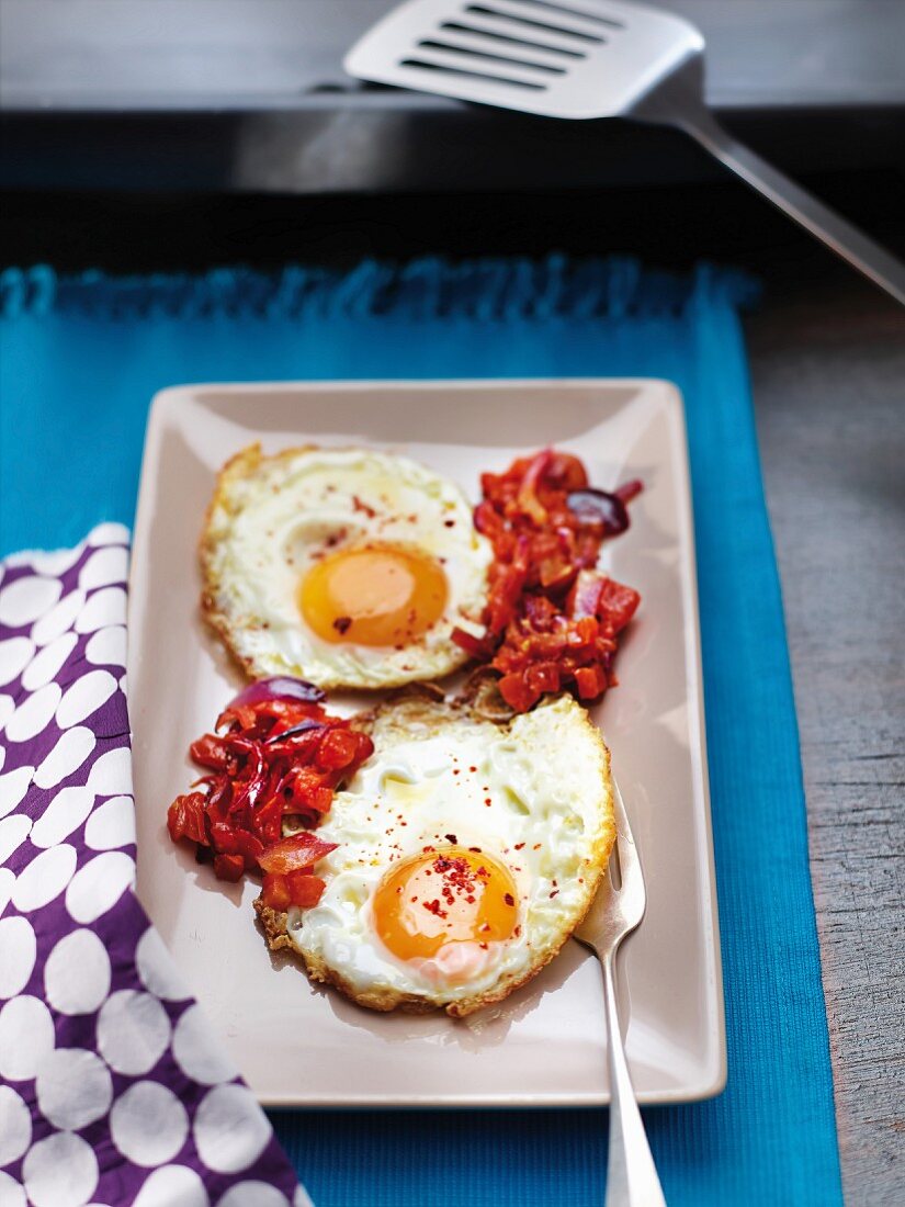 Fried eggs a la plancha with diced tomatoes