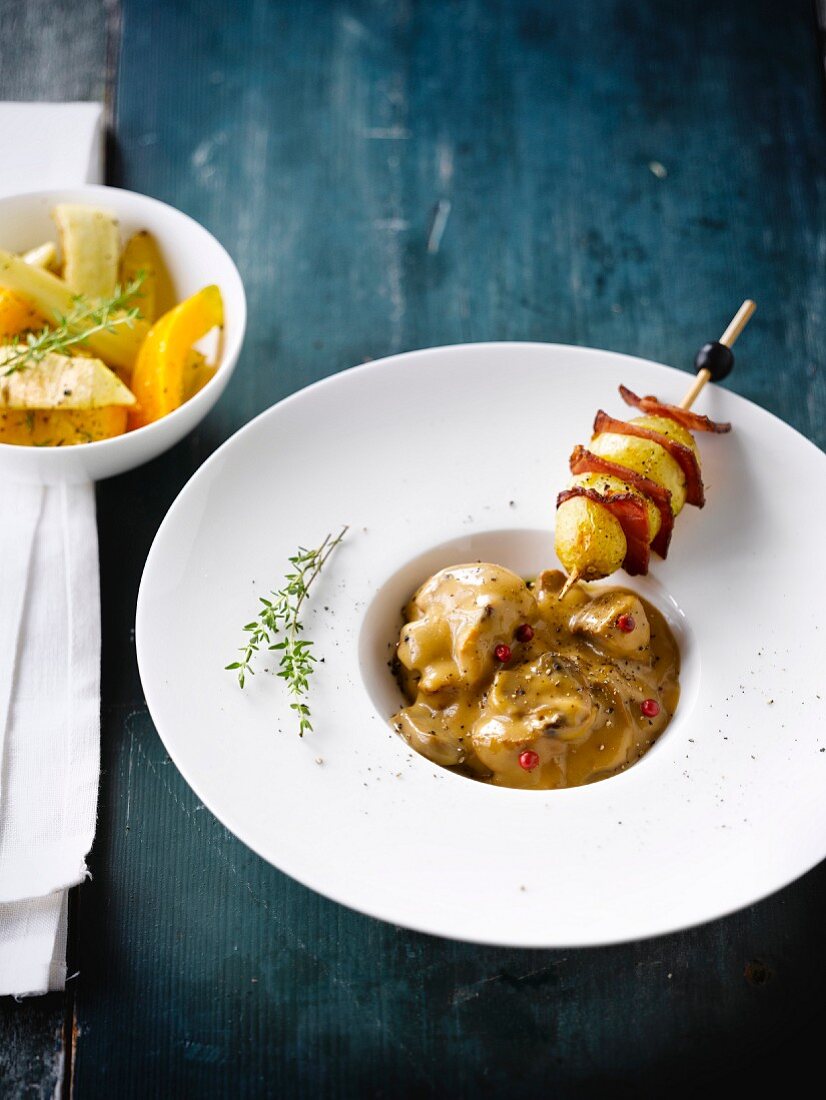 Turkey stew with pink peppercorns,potato and speck brochette and suteed autumn vegetables