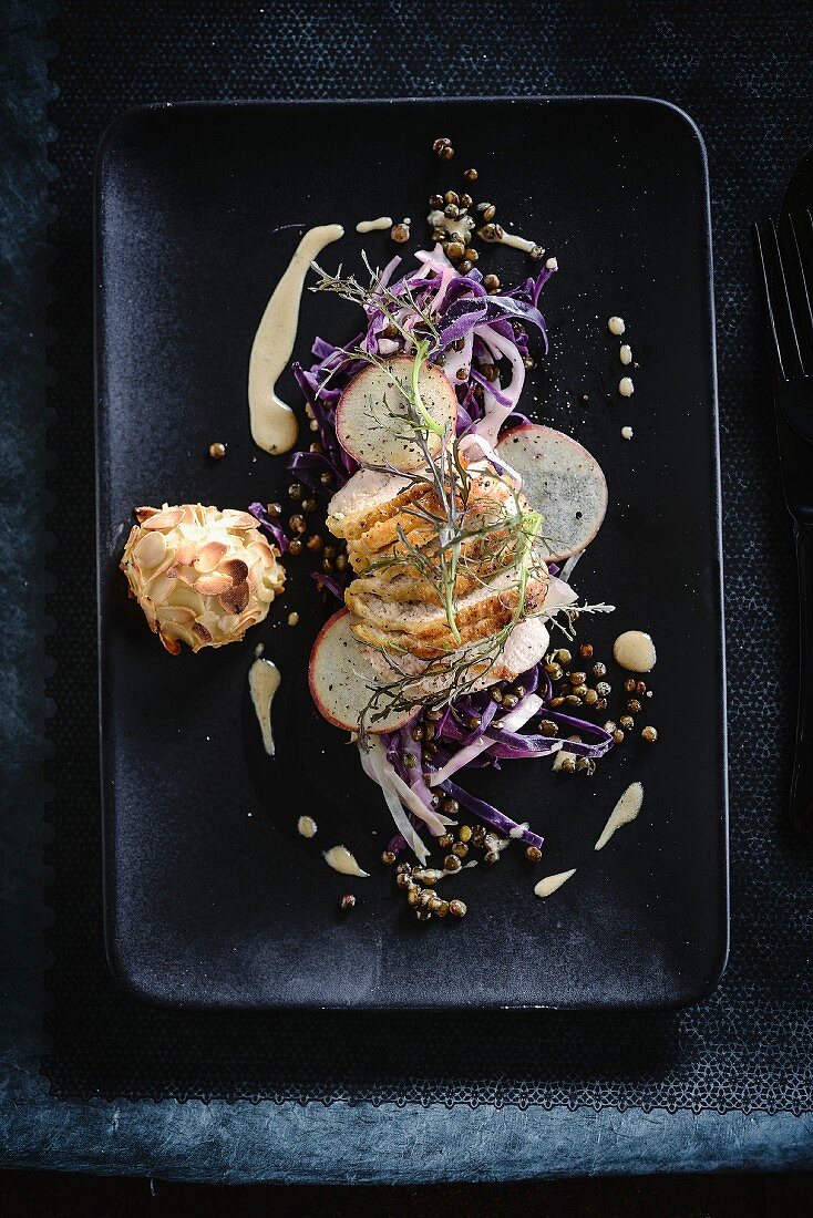 Veal filet mignon with red cabbage and lentils,poached pear coated in thinly sliced almonds