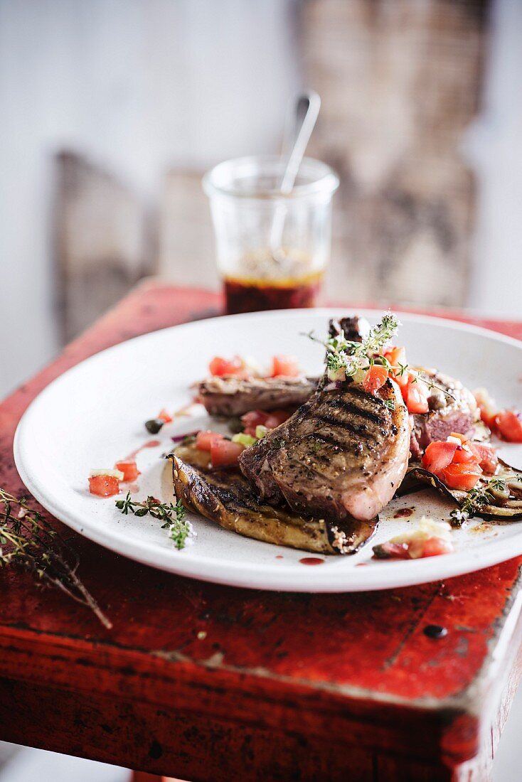 Marinated veal chop with thyme,tomatoes and eggplants