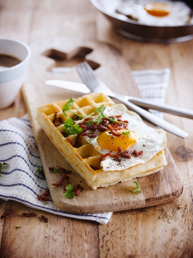 A Brussels waffle with fried egg and bacon