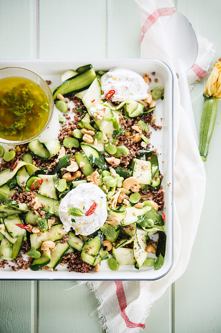 Quinoa salad with courgette, mozzarella, cashew nuts and soft-boiled eggs