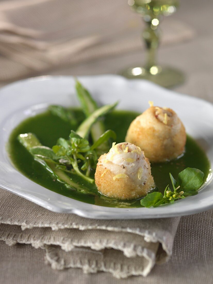 Watercress broth with green asparagus tops,rolled sole fillets in semolina crust