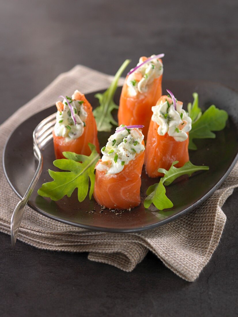 Smoked salmon rolls garnished with shrimp mousse,chives and horseradish