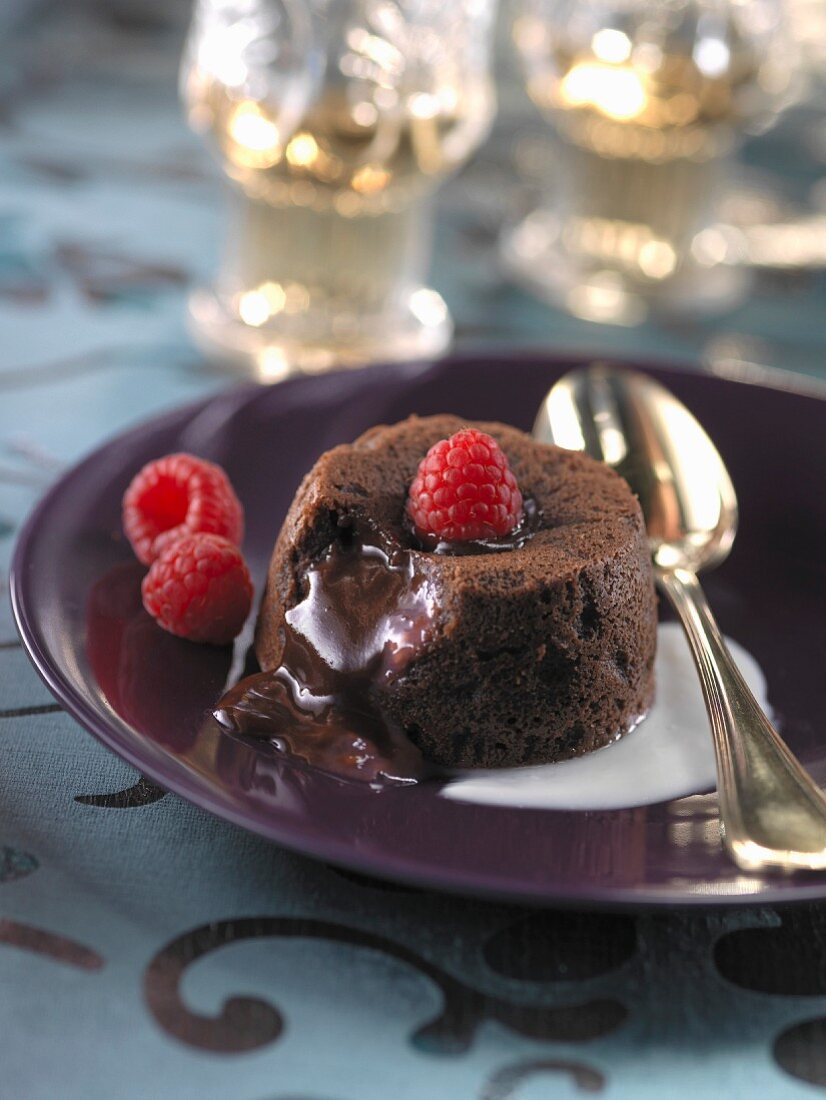 Individual runny chocolate pudding with raspberries,orange-blossom yoghurt cream