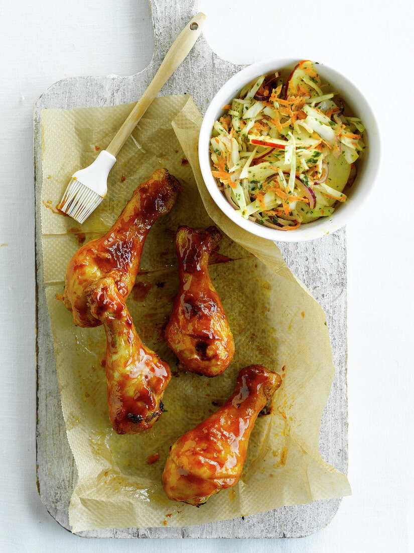 Marinated chicken drumsticks and coleslaw