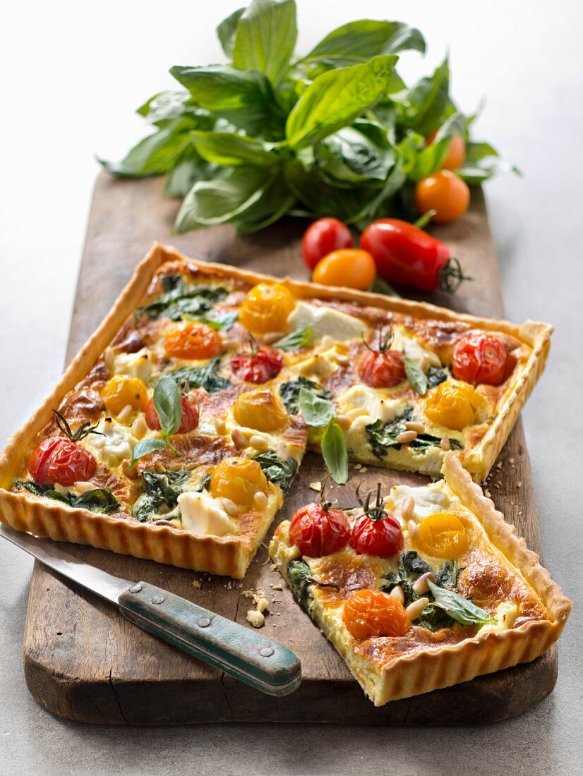 Savoury quiche with ricotta, spinach, cherry tomatoes and pine nuts