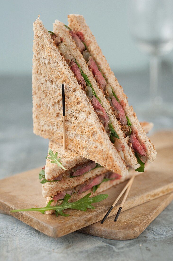 Beef,caramelized onion and rocket lettuce club sandwiches