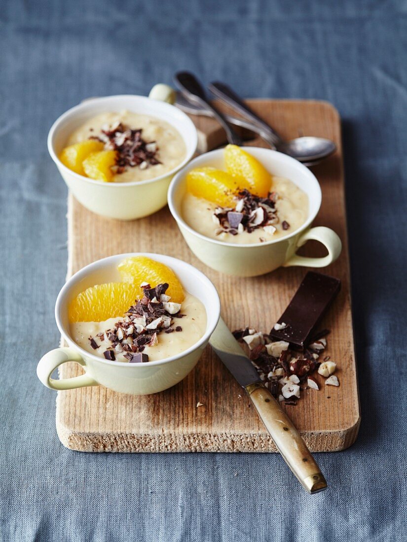 Orange cream dessert with dark chocolate flakes and hazelnuts