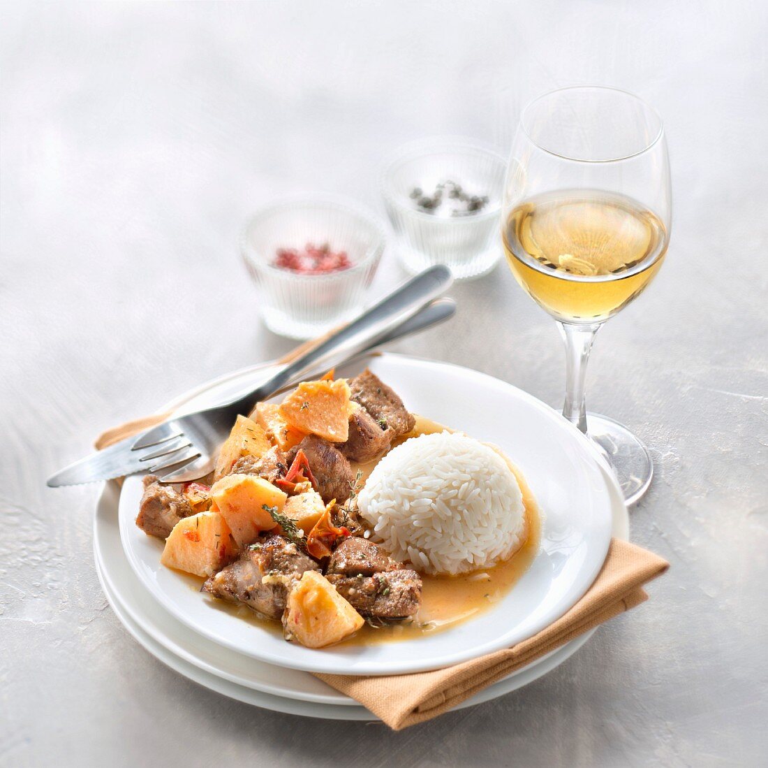 Sauté of lamb with quince and rice, glass of sweet white wine