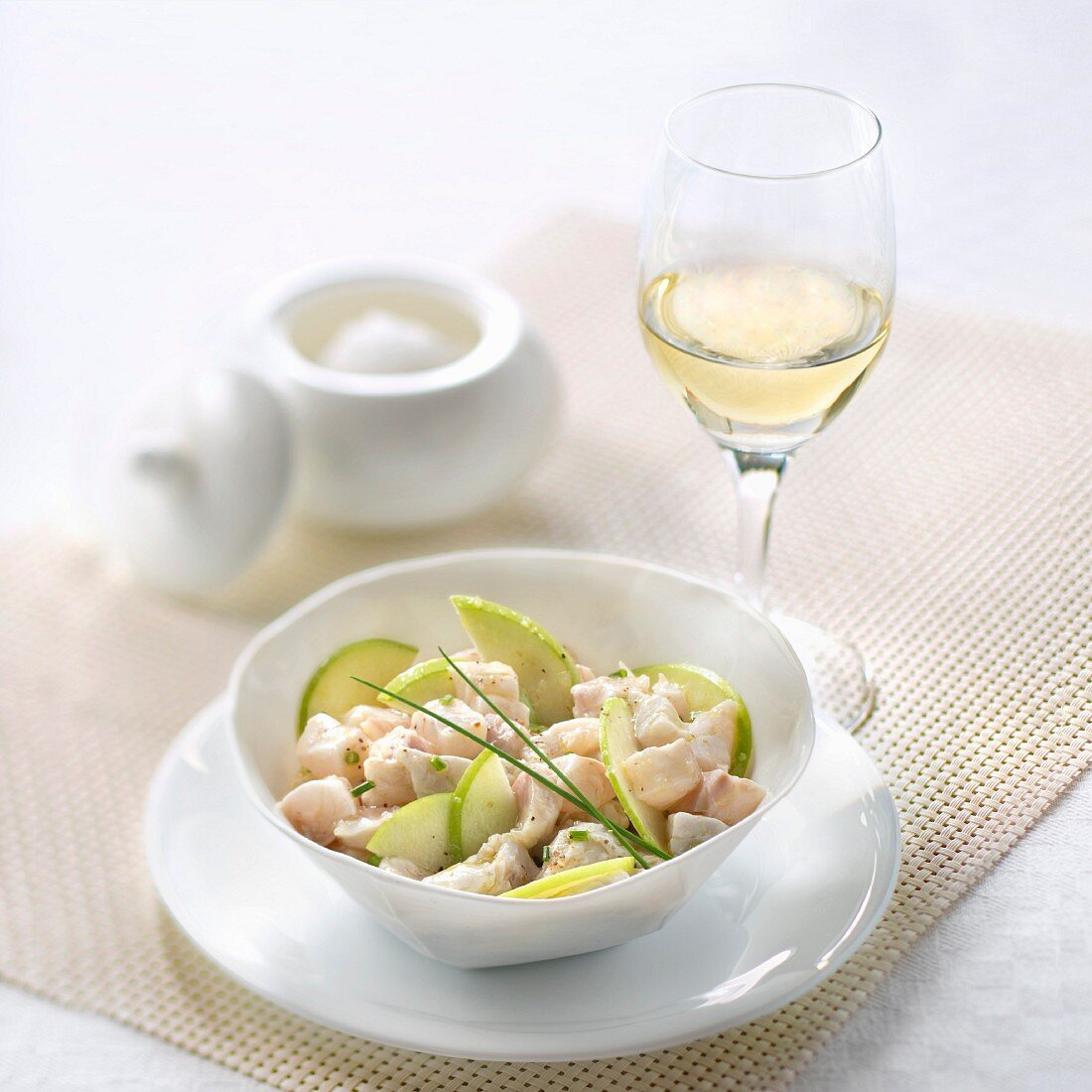 Sea bass tartar with Granny Smith apple, glass of fruity white wine