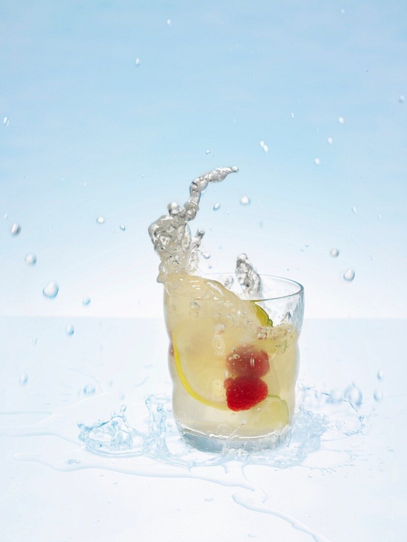 A glass of lemonade with fresh fruit