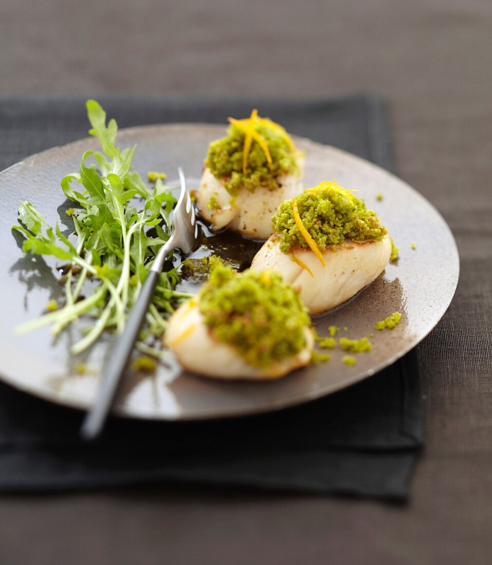 Scallop snacks with pistachio and orange zest topping