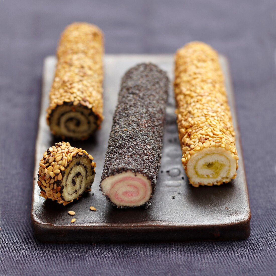 White bread makis coated in sesame and poppy seeds