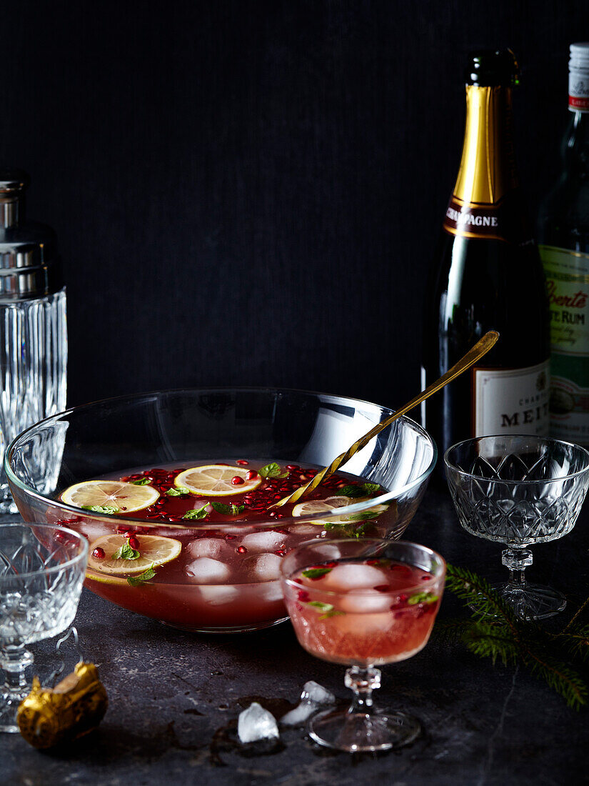 Champagne punch with ice cubes and lemon slices