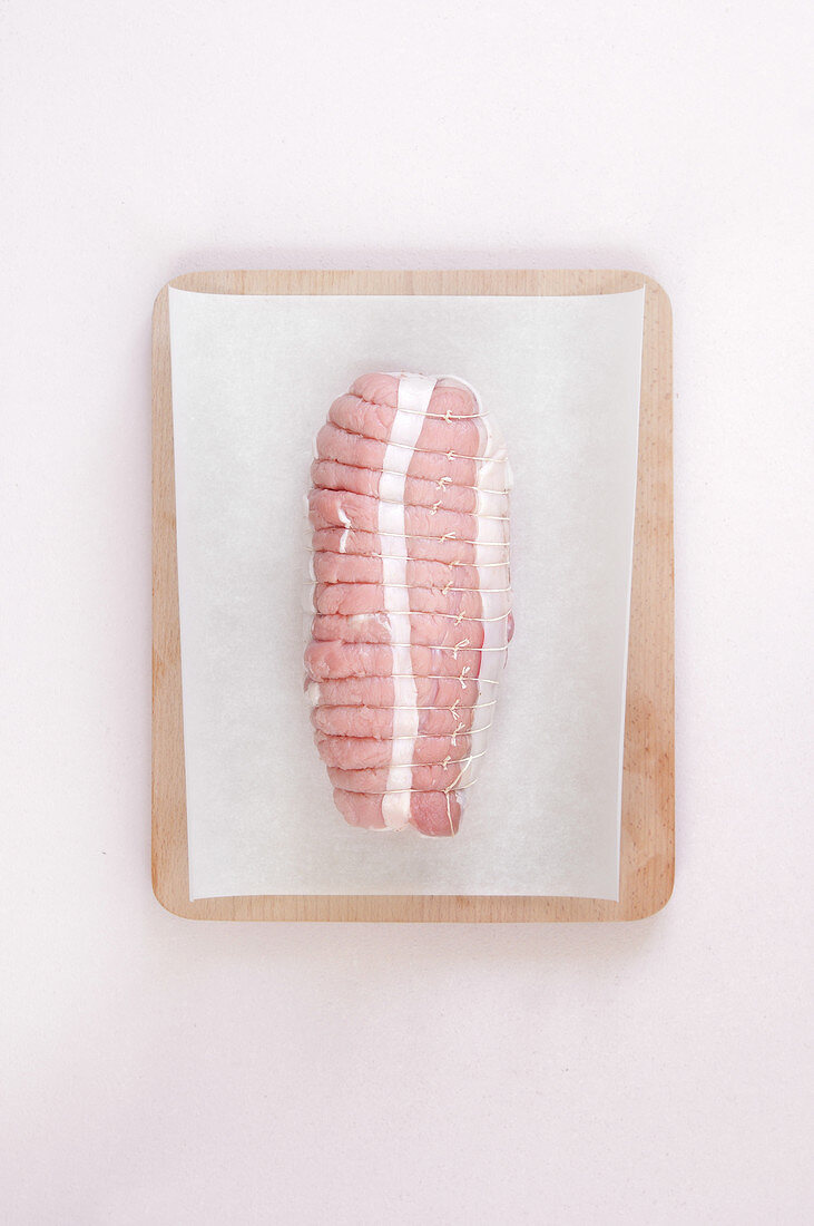 Raw pork roast on a sheet of wax paper