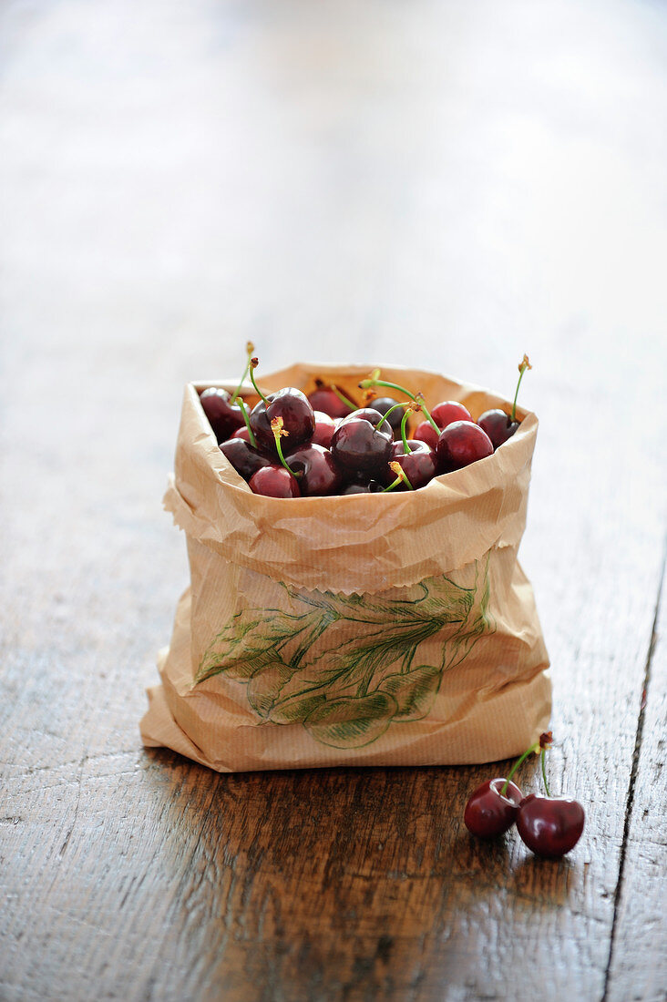 Cherries in a brown paper bag