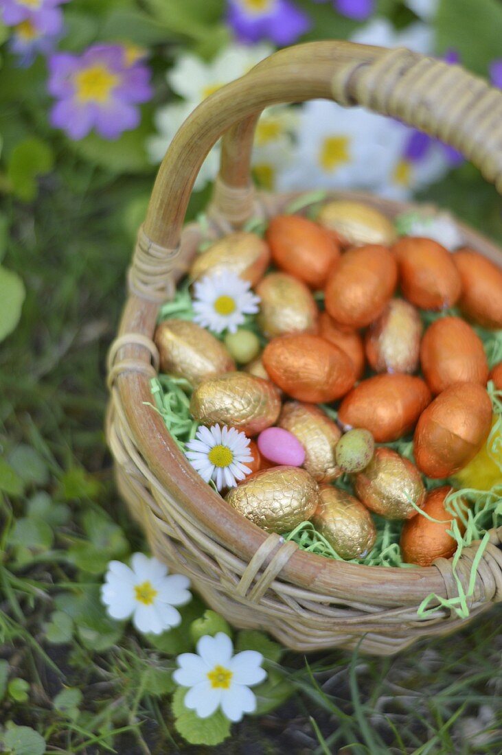 Small basket of Easter eggs in the grass