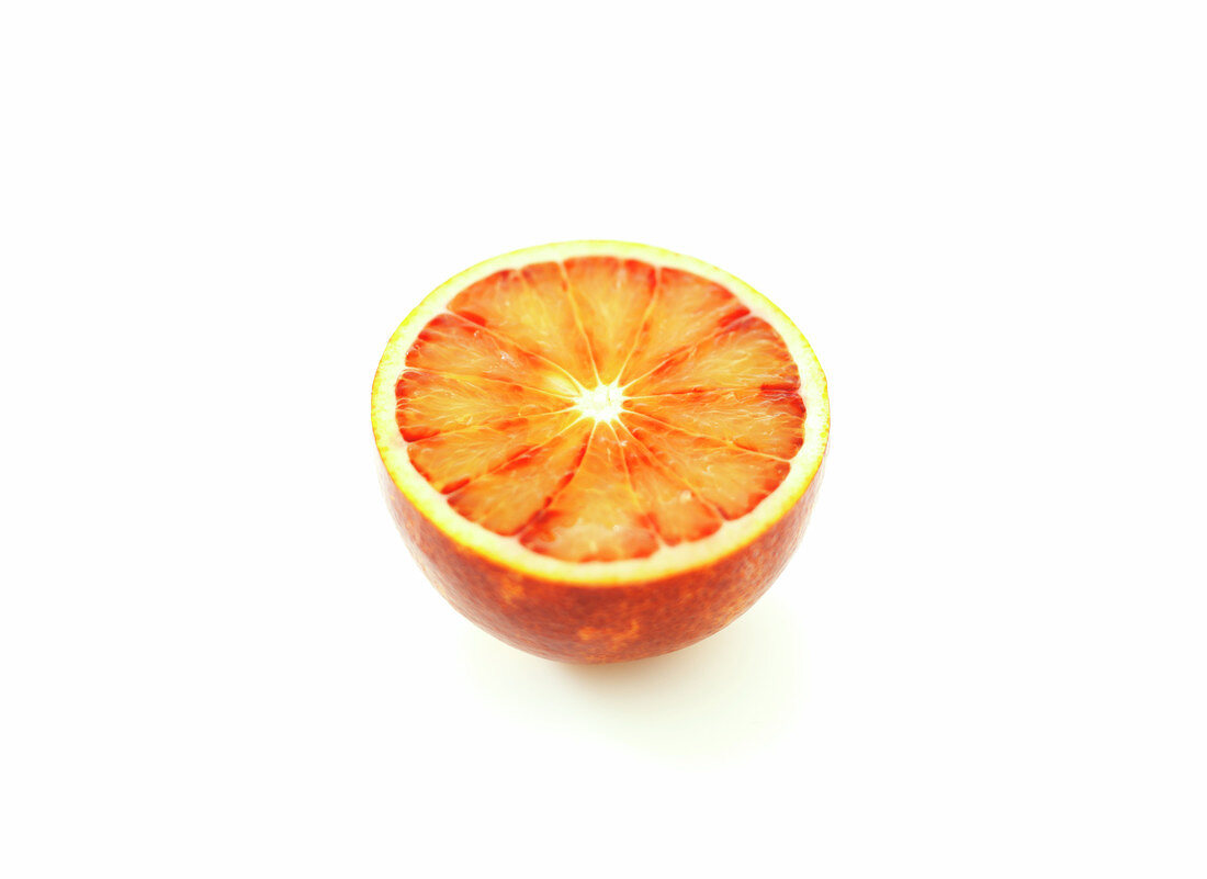 Half a blood orange on a white background