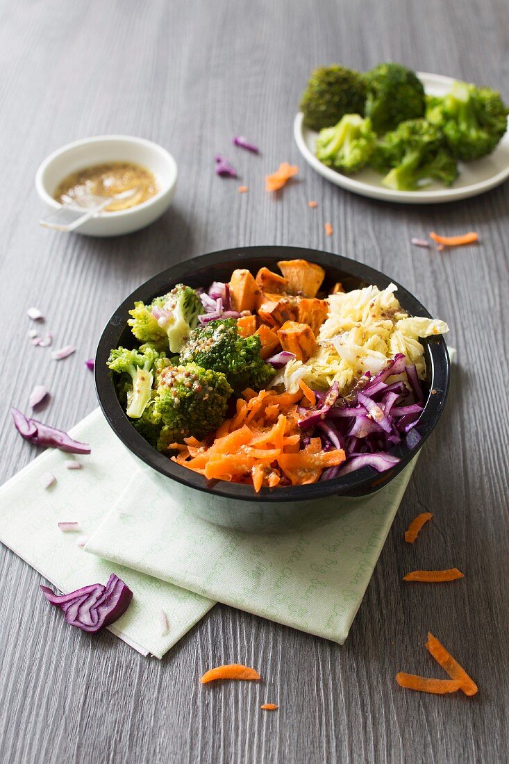 Broccoli, red and white cabbage, carrot and sweet potato Buddha bowl