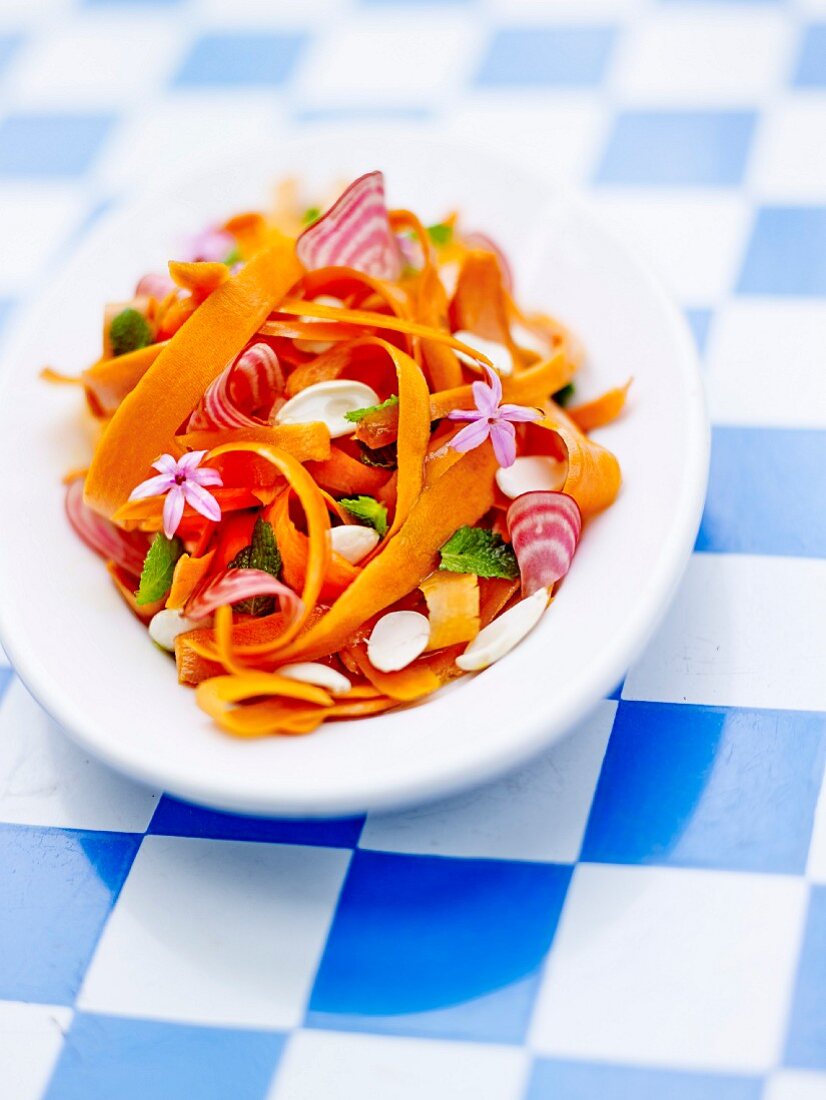 Pumpkin, beetroot and almond salad with mint leaves and flowers