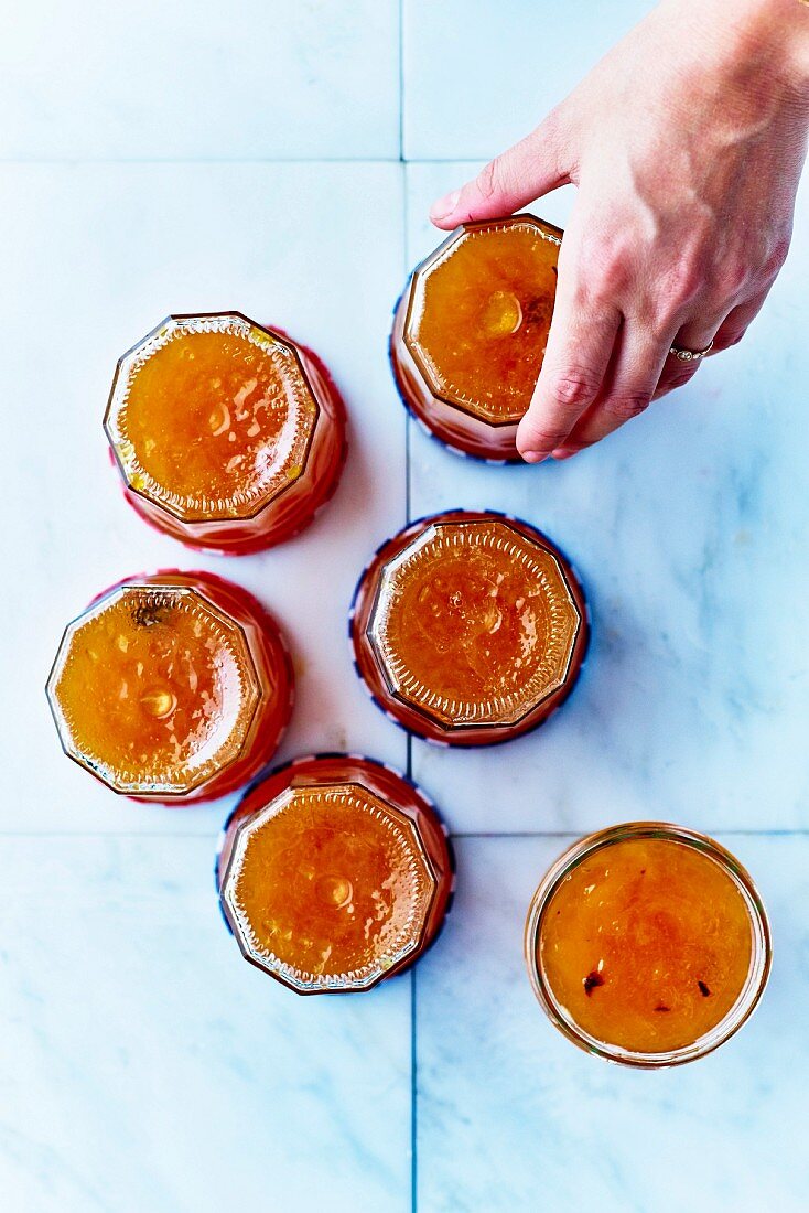 Turning upside down jars of cinnamon-flavored plum jam